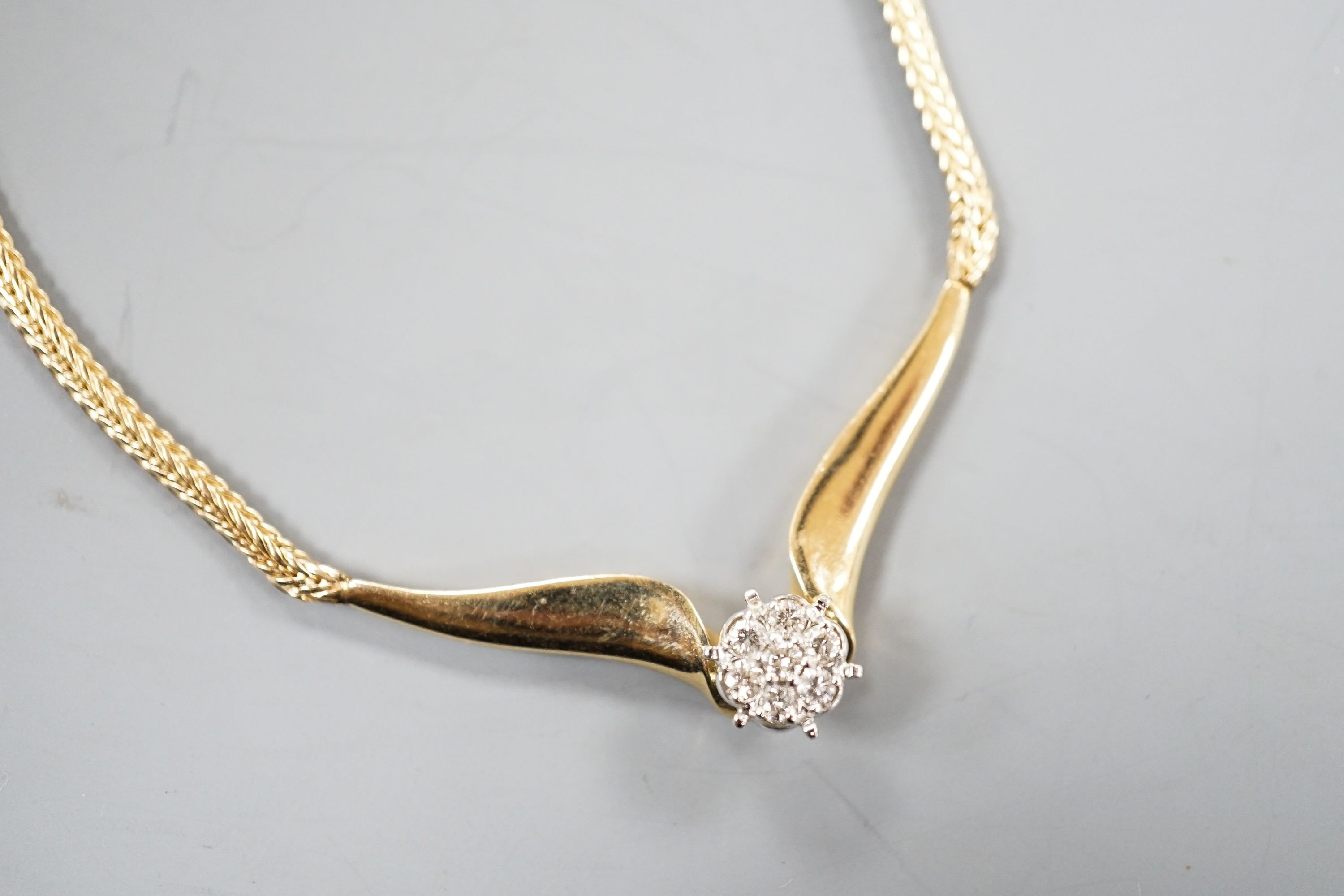 A modern 14k yellow metal and seven stone diamond cluster set necklace, 38cm, gross weight 12.3 grams.